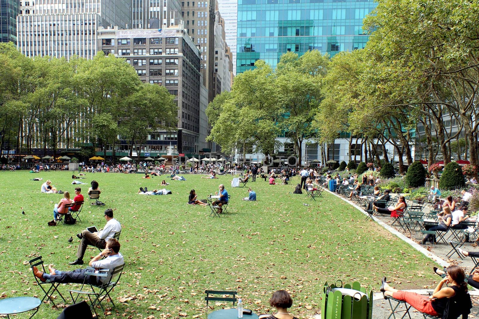 NEW YORK -SEPTEMBER 03: People enjoying at lunch time in Bryant Park on September 03, 2013 in New York City, NY. Bryant Park is a 9,603 acre privately managed park in the center of Manhattan