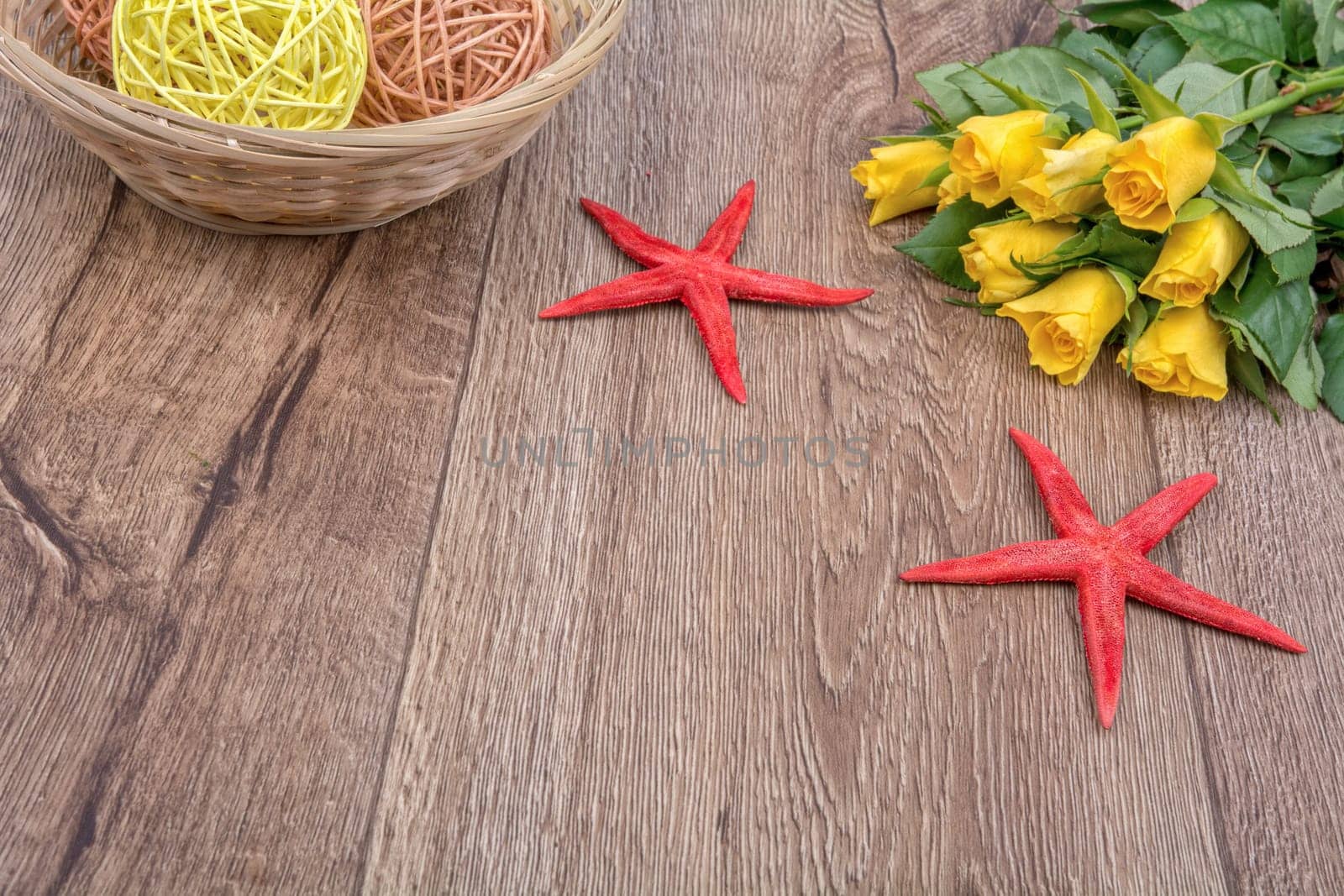 Red starfishes and orange yellow on a wooden background