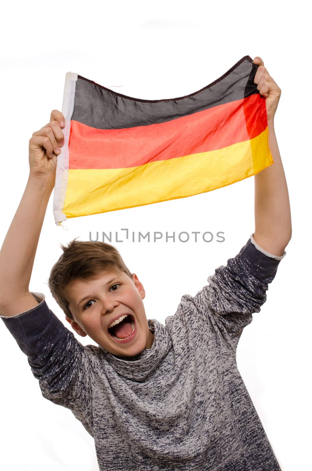 Happy young boy with a German flag on a white background