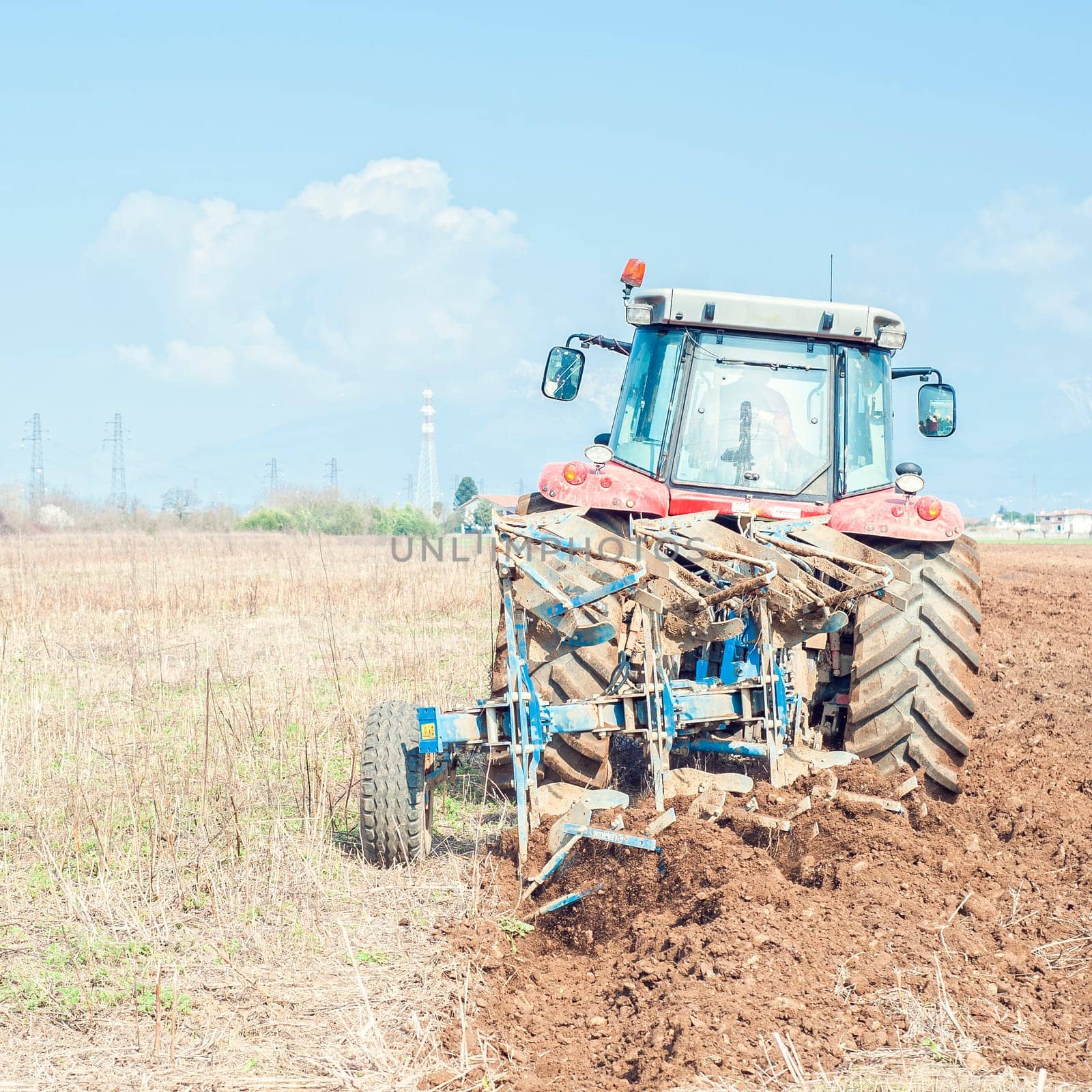 Agricultural work.  Tractor plowing the stubble field