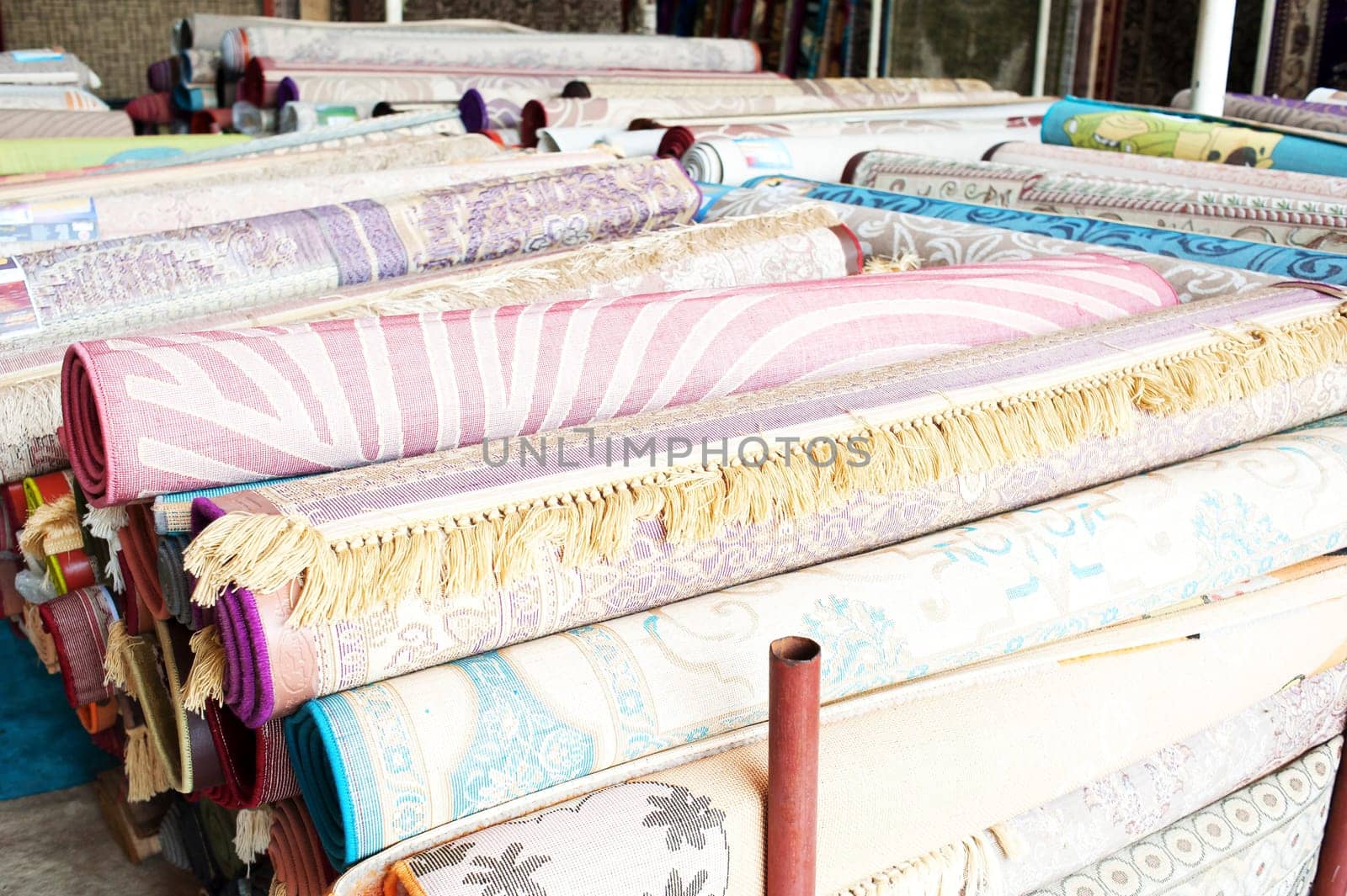 Many colorful carpets for sale  in the store.