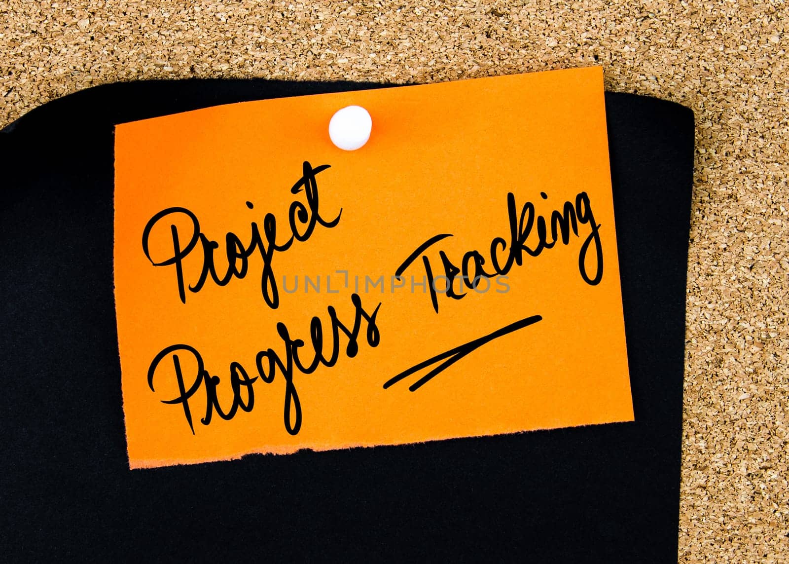 Project Progress Tracking written on orange paper note pinned on cork board with white thumbtacks, copy space available