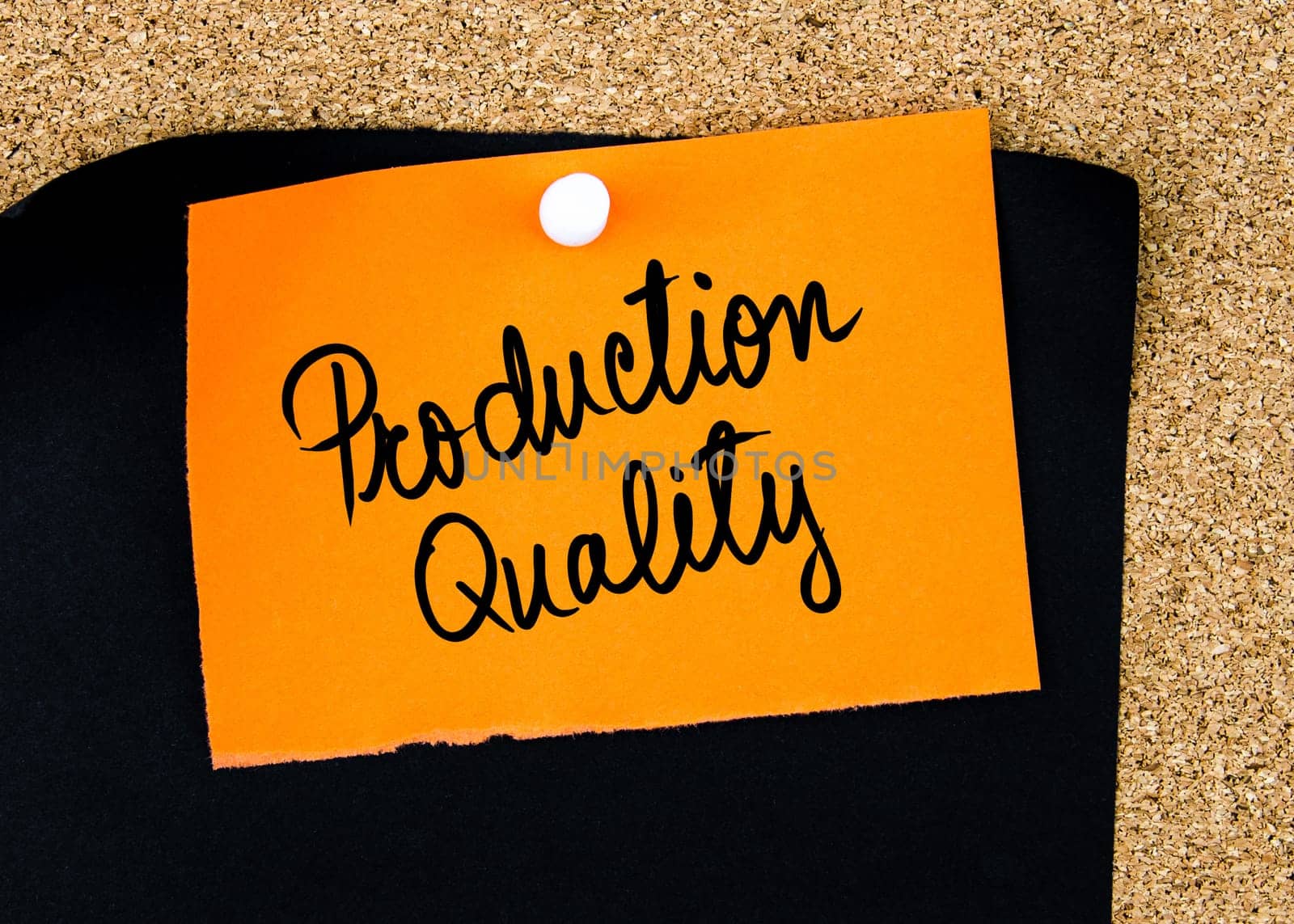 Production Quality written on orange paper note pinned on cork board with white thumbtacks, copy space available