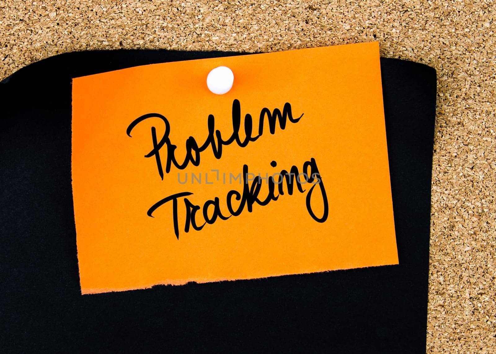 Problem Tracking written on orange paper note pinned on cork board with white thumbtacks, copy space available