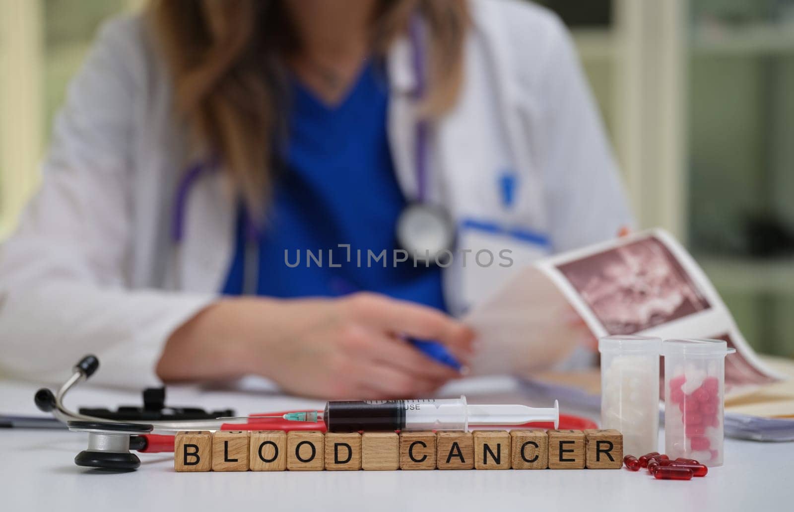 A healthcare professional examines blood cancer samples and documents everything, clearly highlighting the diagnosis