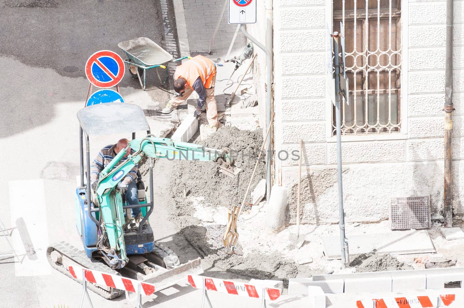 Sidewalk under construction, curb and gutter installation in progress  Construction workers.