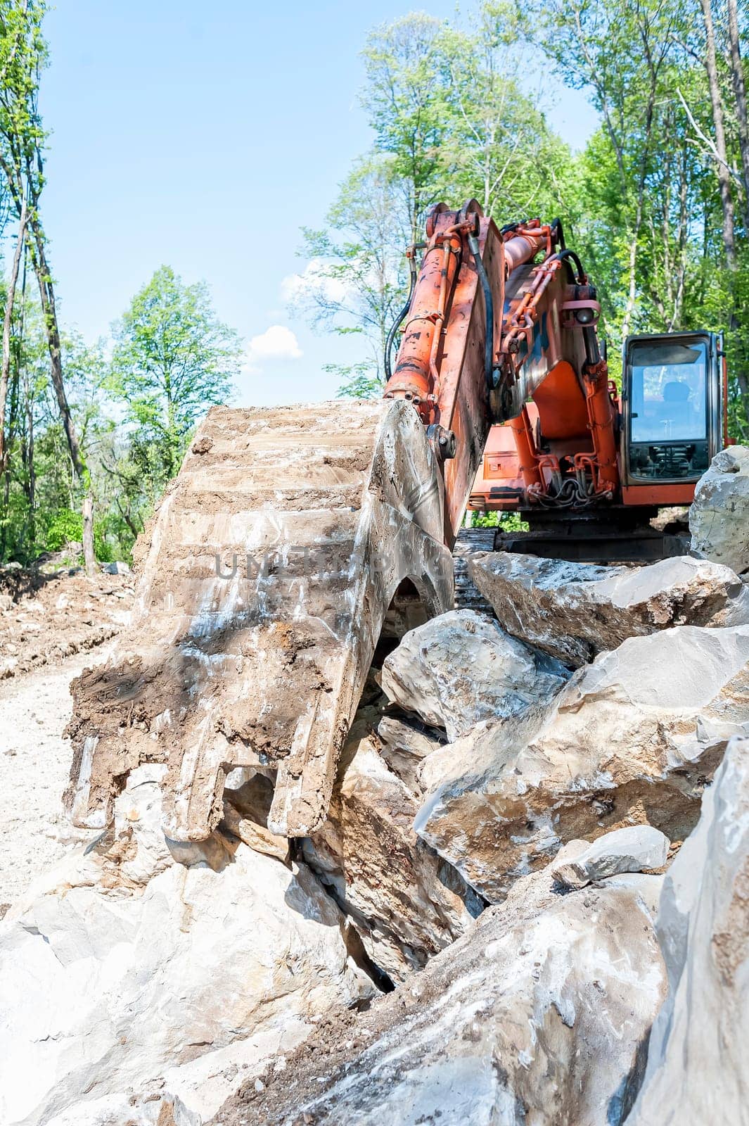 Excavator with big shovel to work with rocks