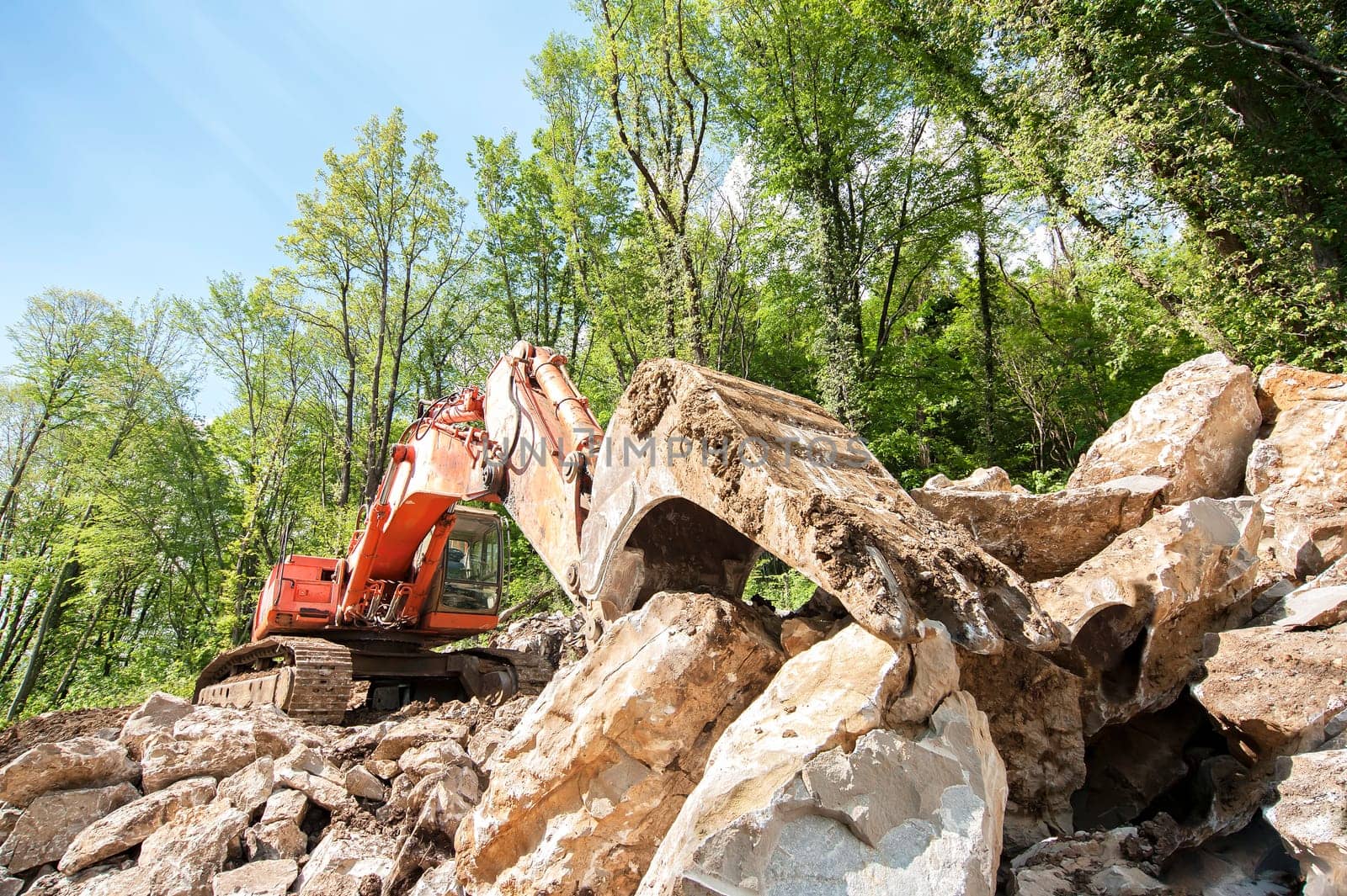 Excavator with big shovel to work with rocks