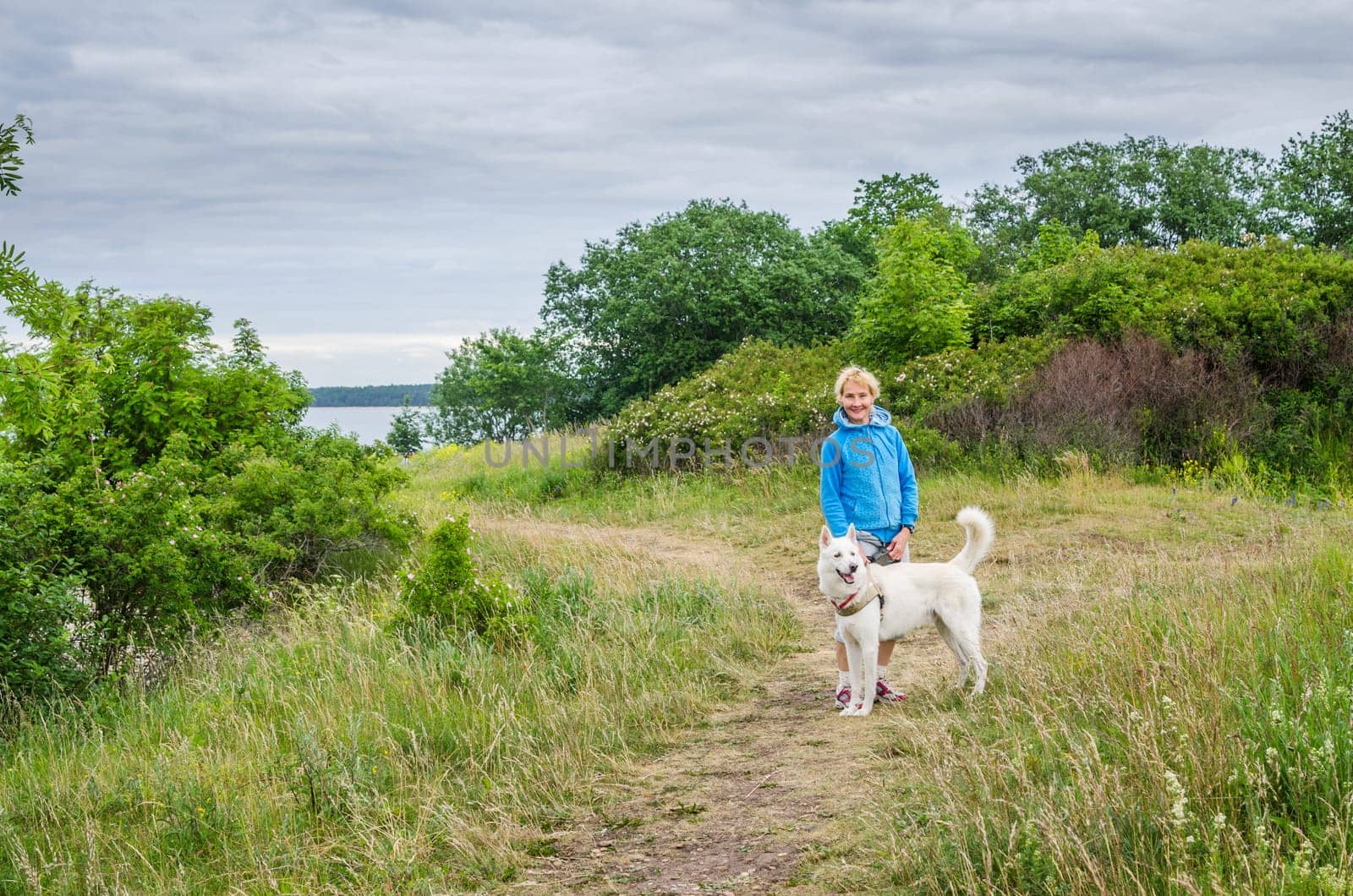 A woman with a dog on the beach