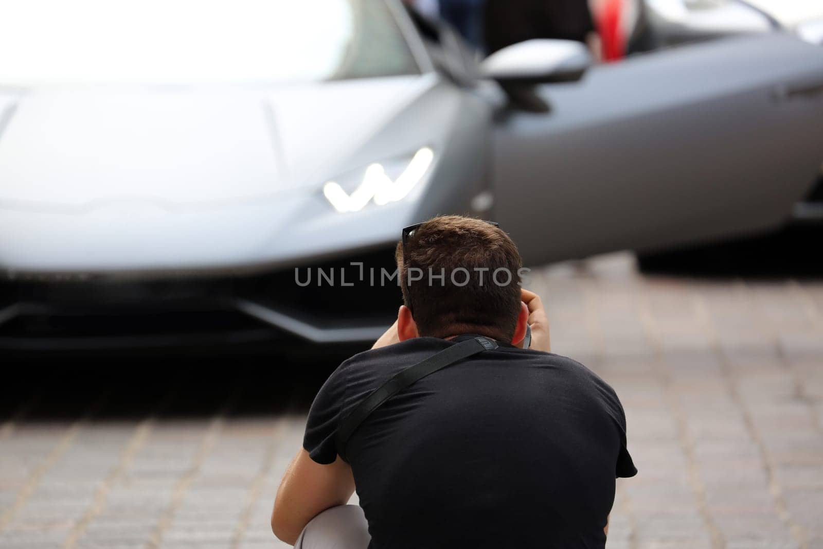 Professional Photographer Takes a Picture of a Beautiful Italian Supercar