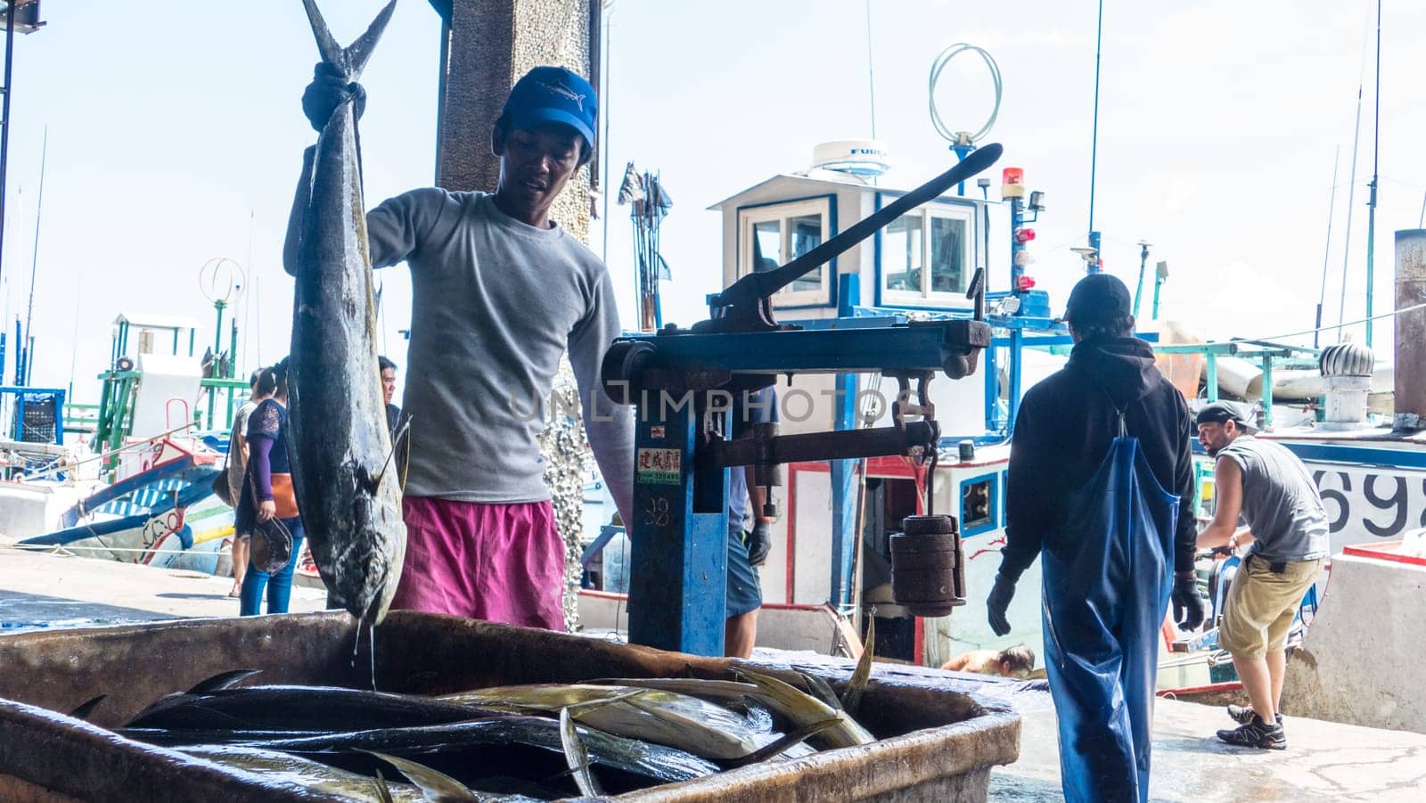 Taitung, Taiwan - May 28, 2016 : Fishing boats docked Chenggong Fishing Harbor remove fishing goods