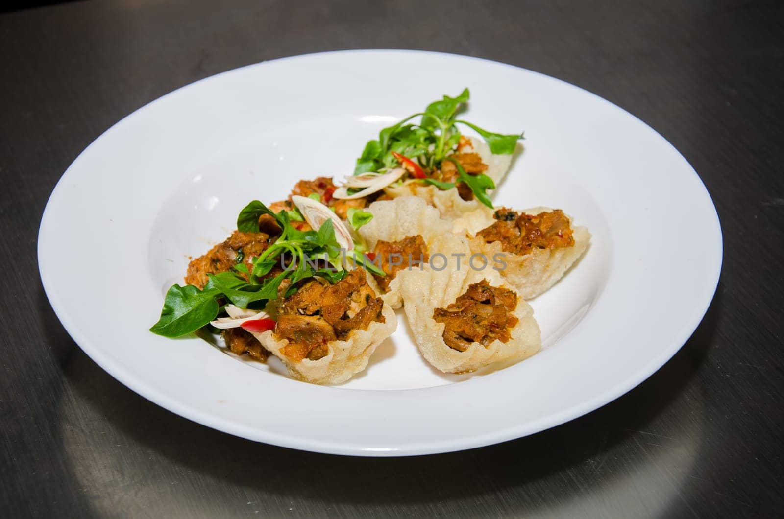 Thai basil pork stir fry (stir-fried pork and basil) in mini basket. Thai cuisine.