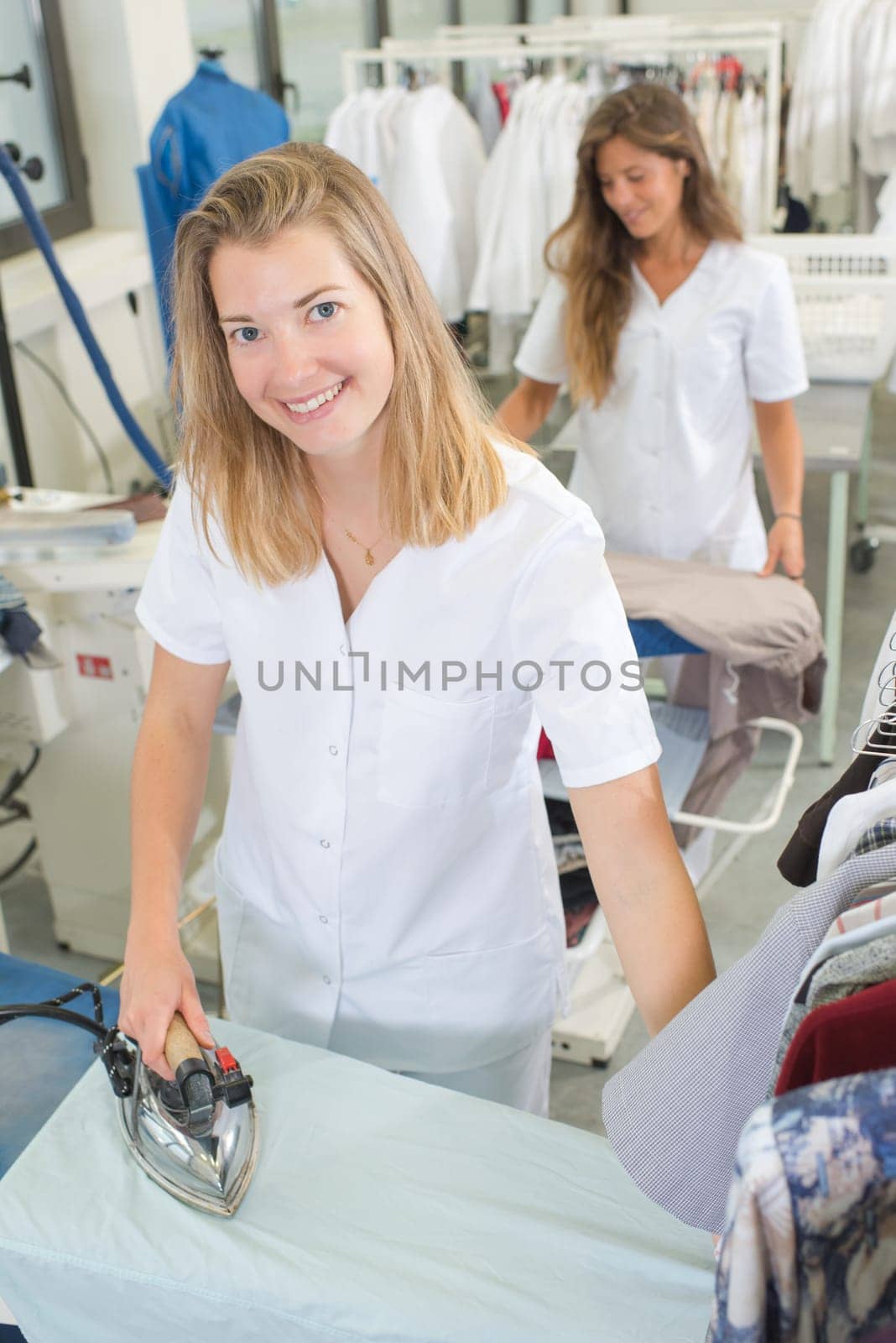 young woman ironing clothes