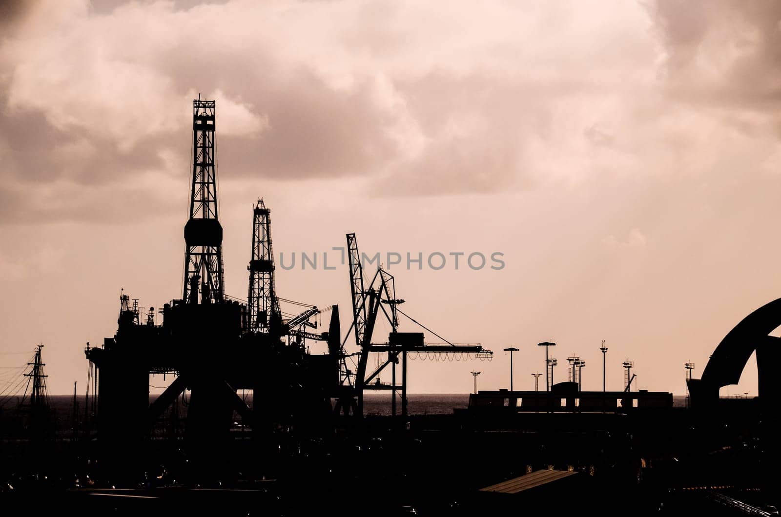 Oil Drilling Rig Silhouette over a Cloudy Sky