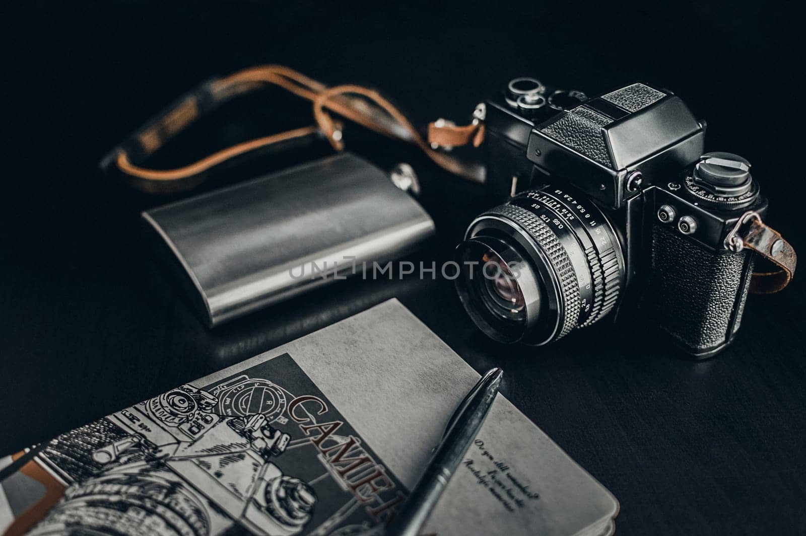 Retro Camera With Notebook On Dark Background