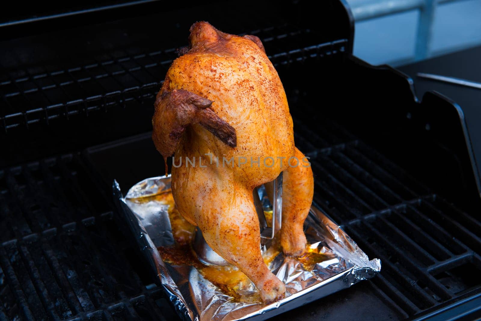 crunchy grilled completely chicken sitting on barbecue