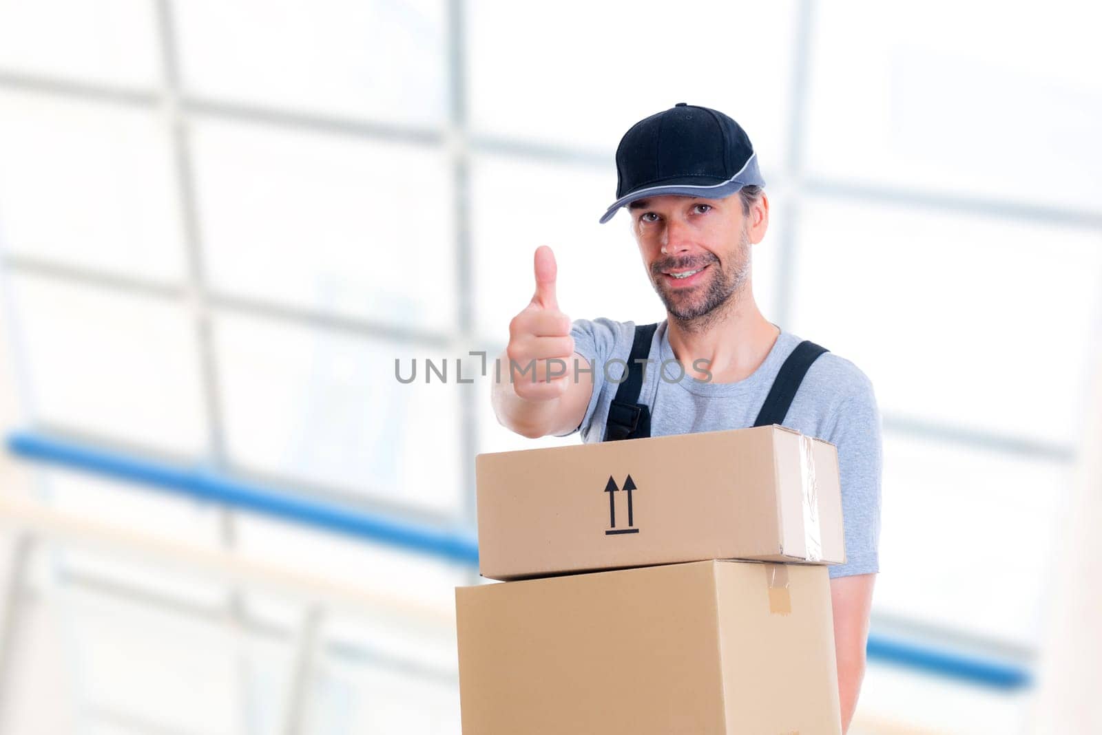 friendly postman with parcels and thumb up looking friendly