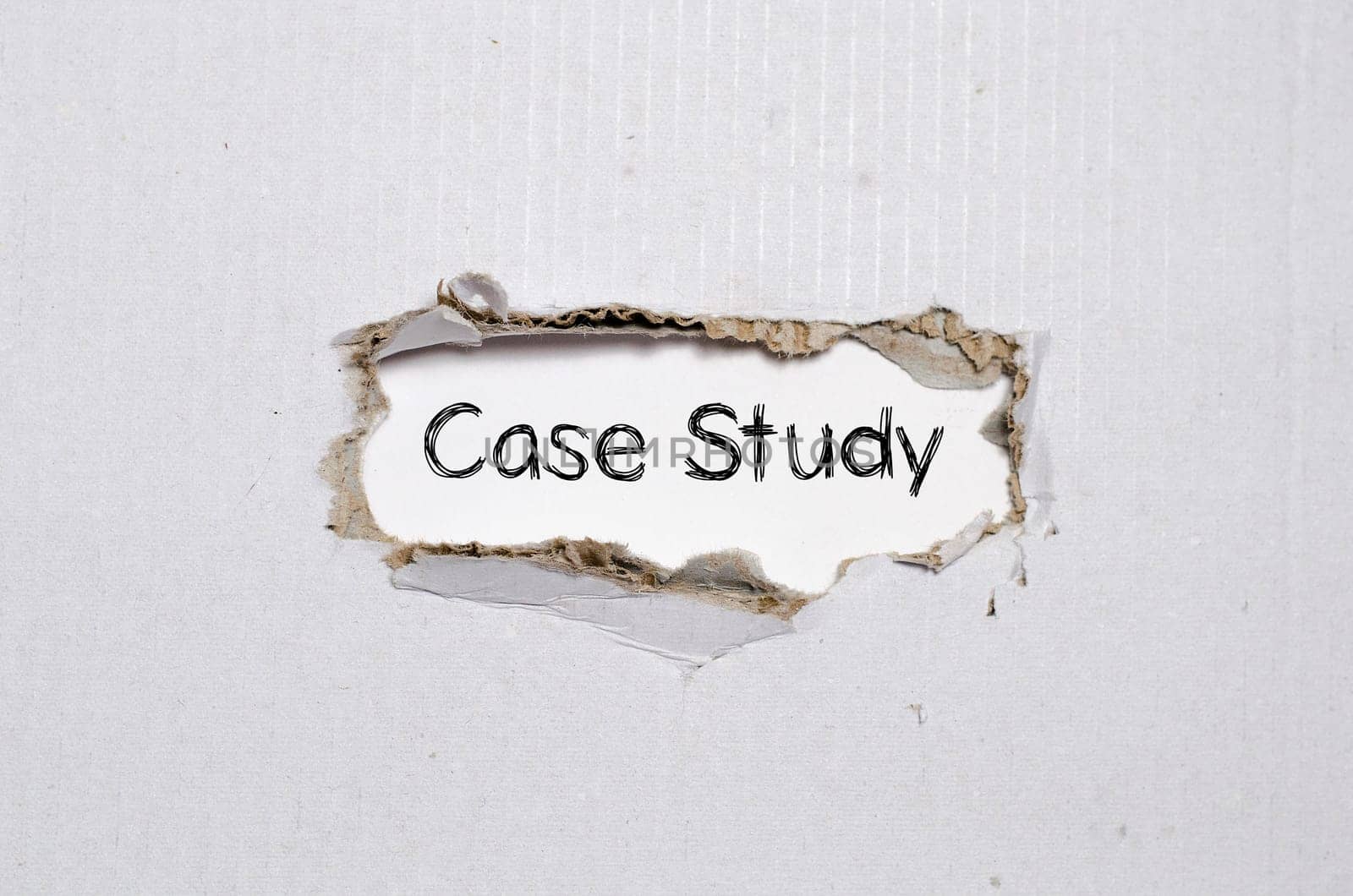 The word case study appearing behind torn paper.