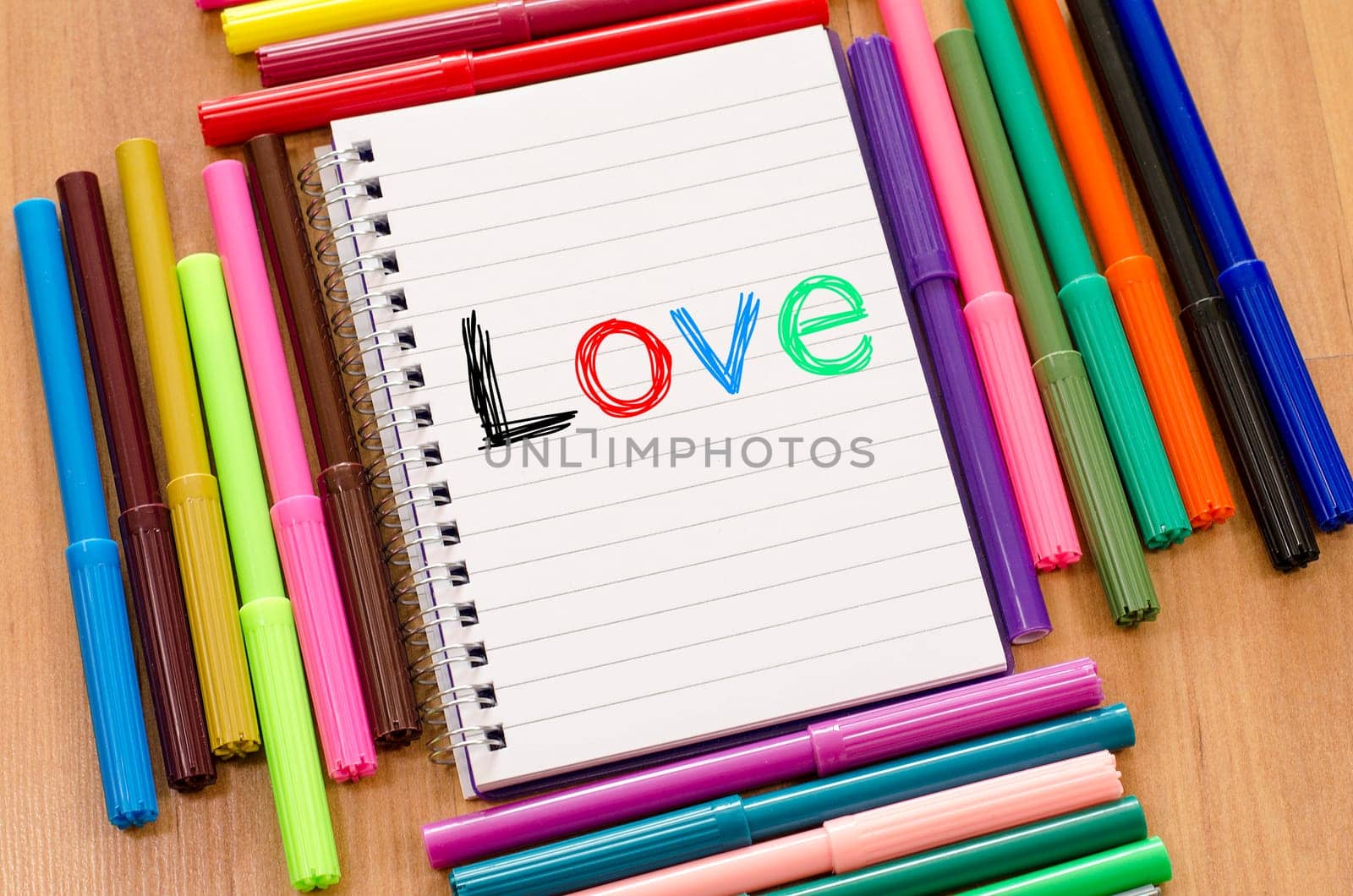 Felt-tip pen and notepad on a wooden background