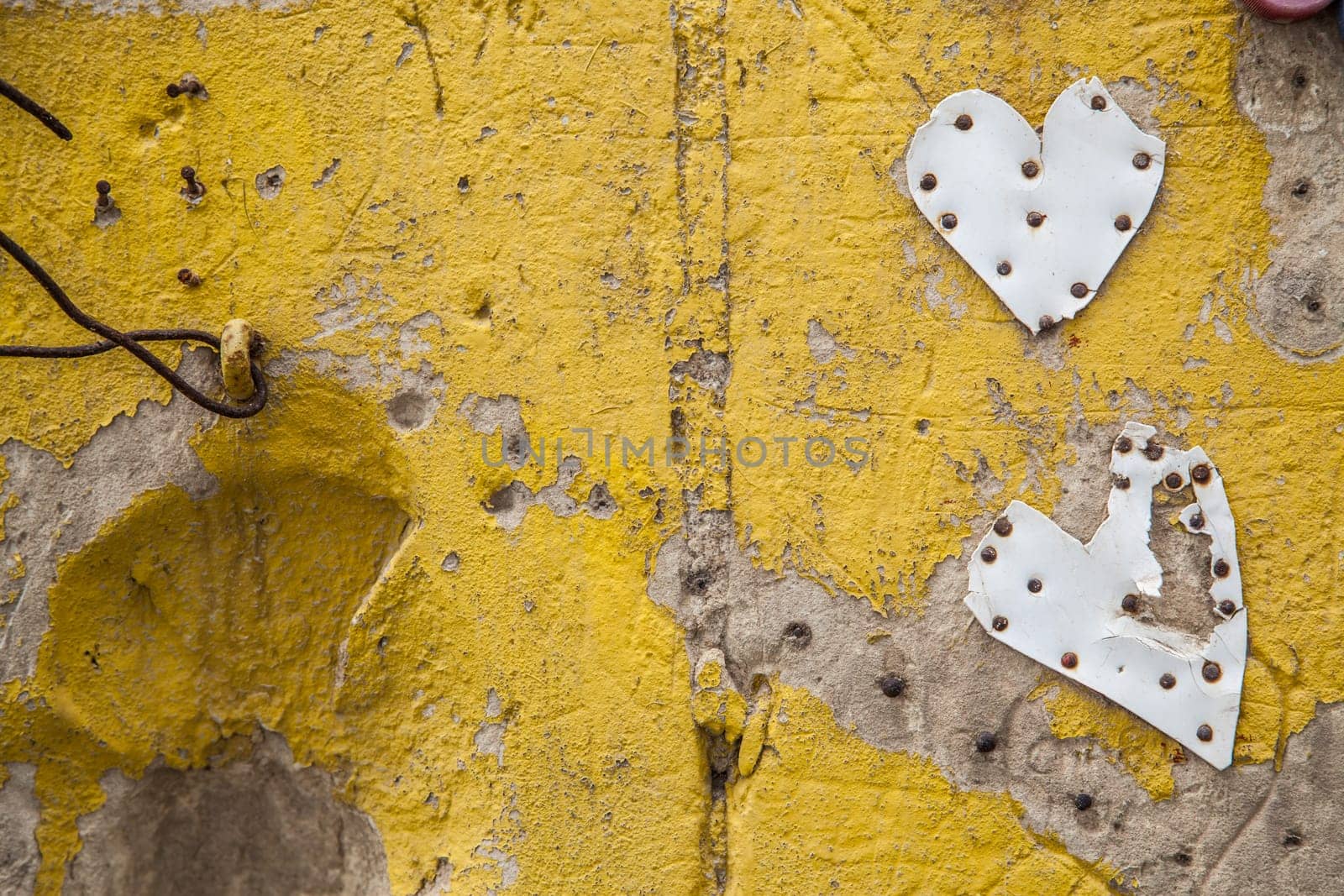 Hand painted yellow wall with plastic made hearts