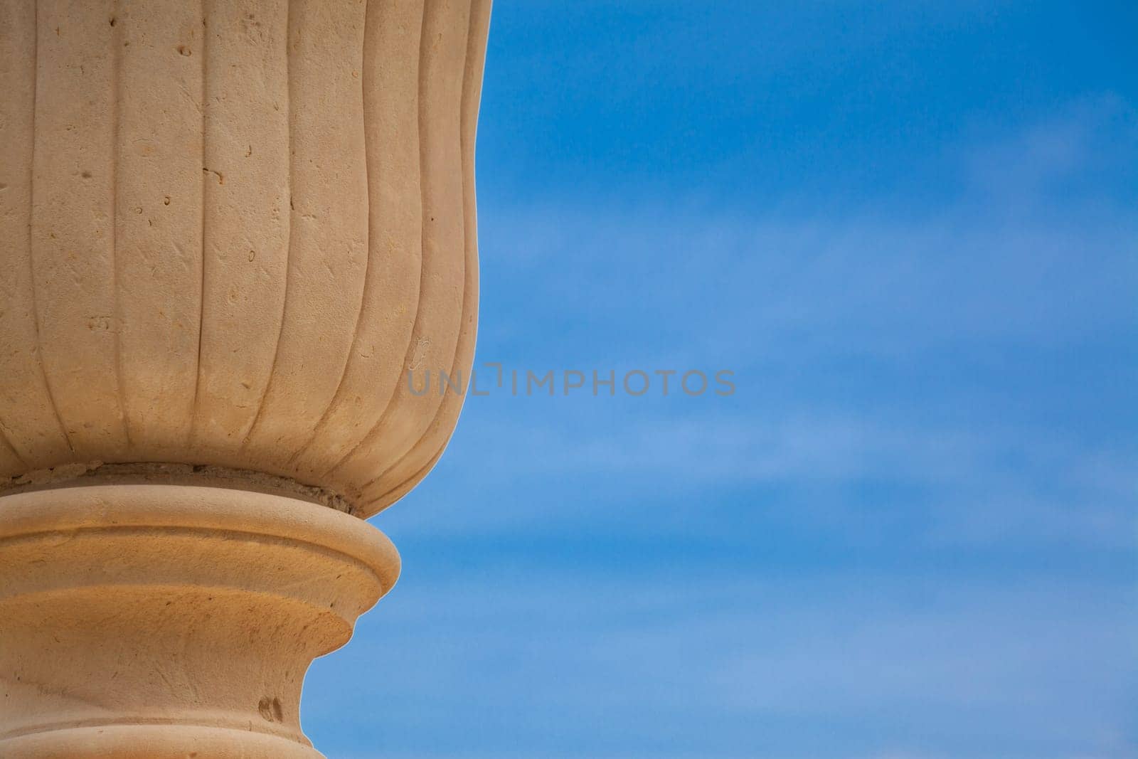 An ancient vase over a blue spring sky