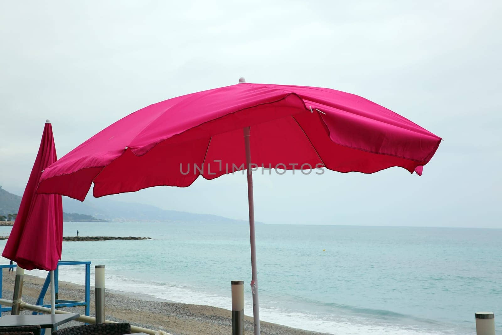 Pink Parasol By The Sea at Roquebrune-Cap-Martin, France.