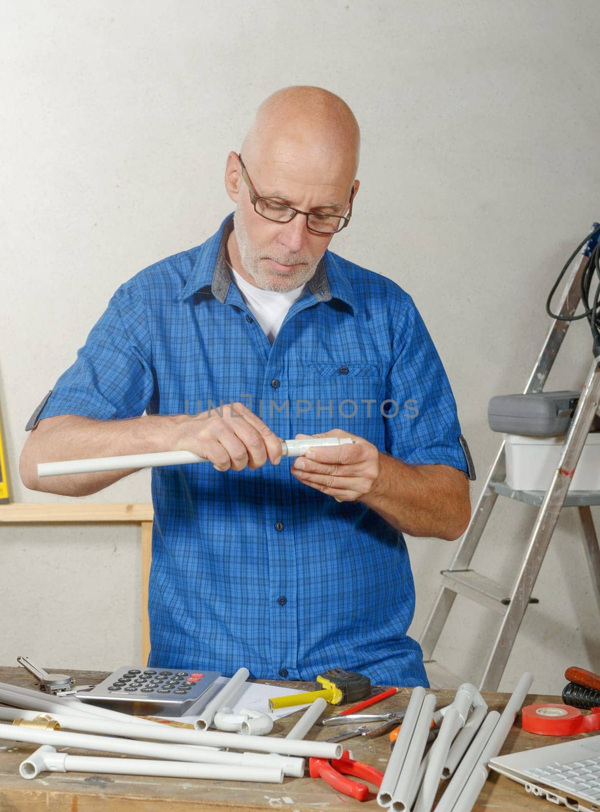 a portrait of mature handyman at DIY workshop