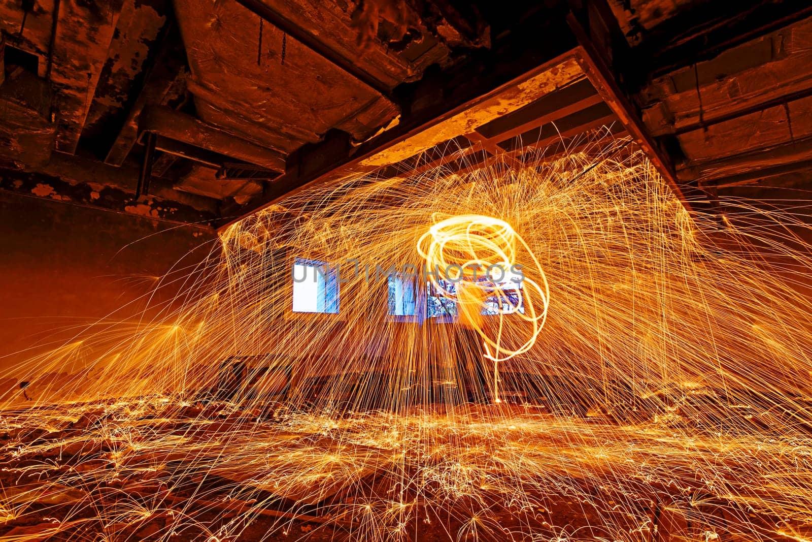 Burning Steel Wool spinning. Showers of glowing sparks from spinning steel wool in ruins
