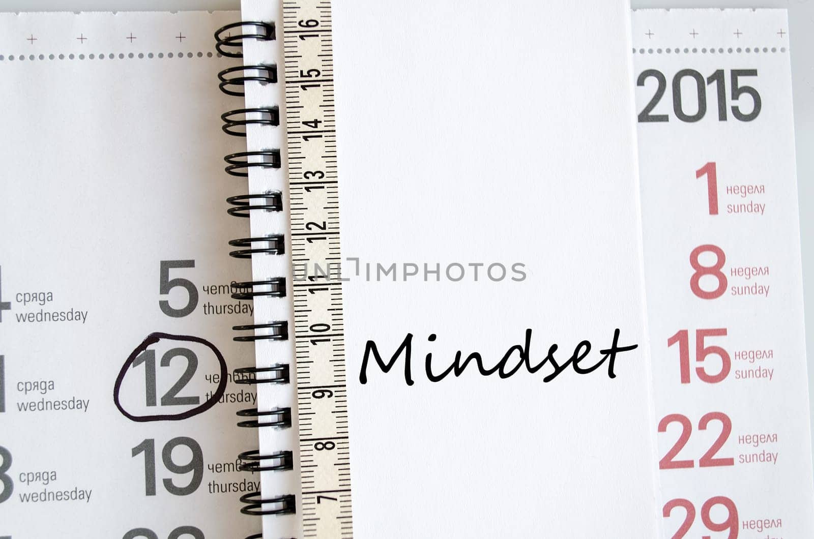 Mindset text concept over tape measure and calendar background..