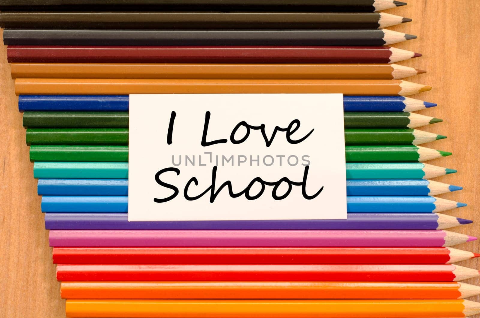 I love school text concept and colored pencil on wooden background