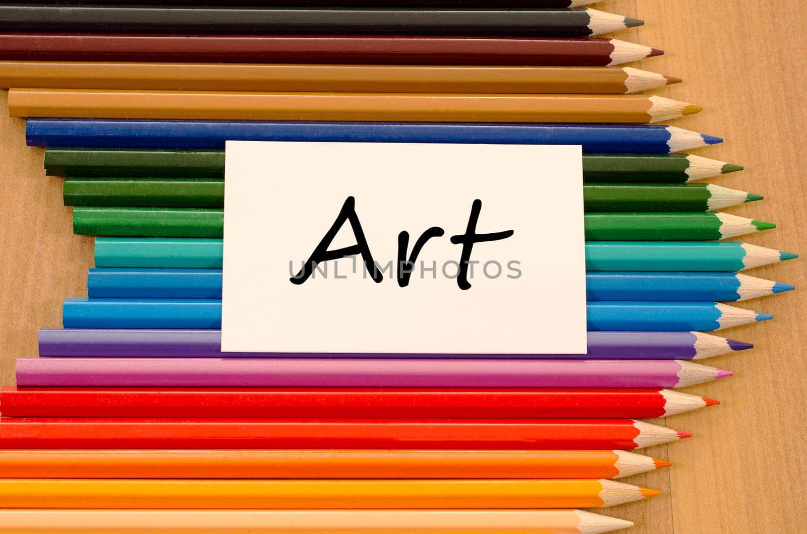 Art text concept and colored pencil on wooden background