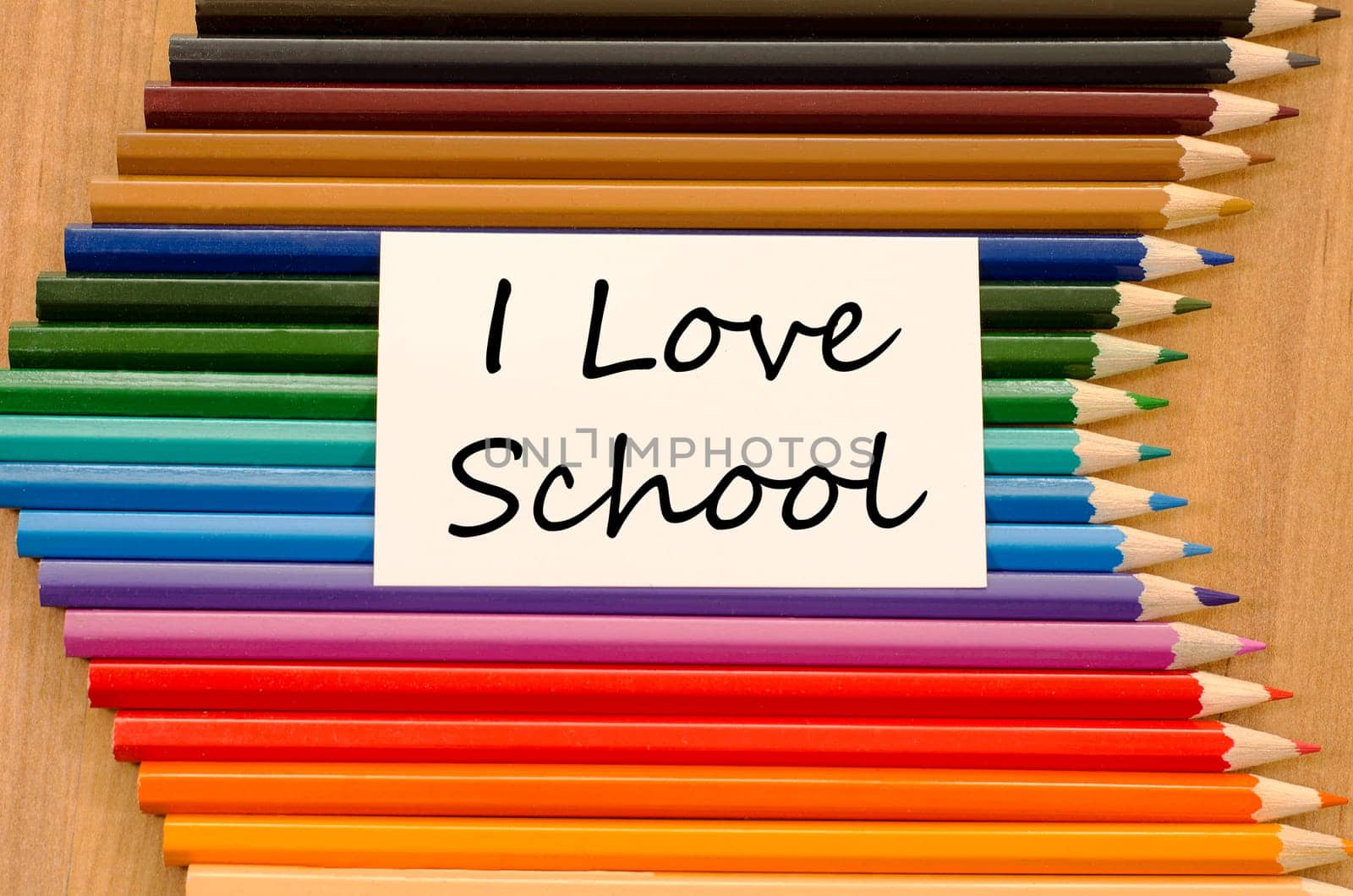 I love school text concept and colored pencil on wooden background