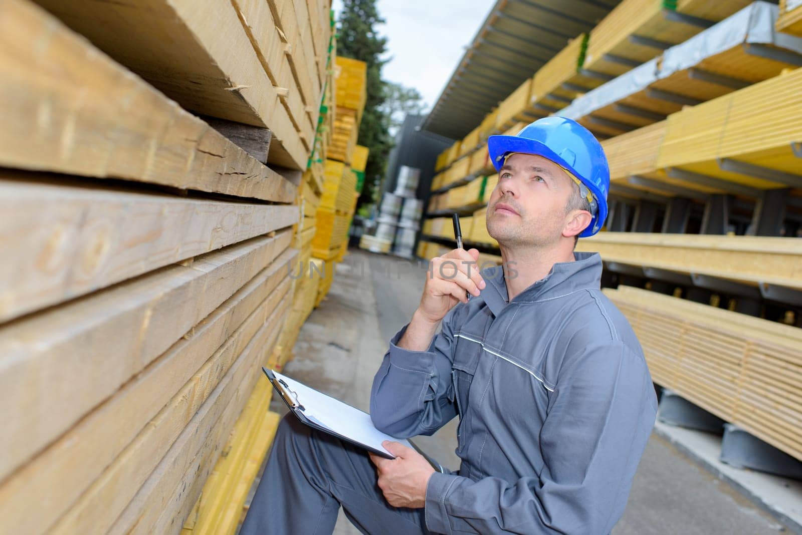 man taking a note in the warehouse