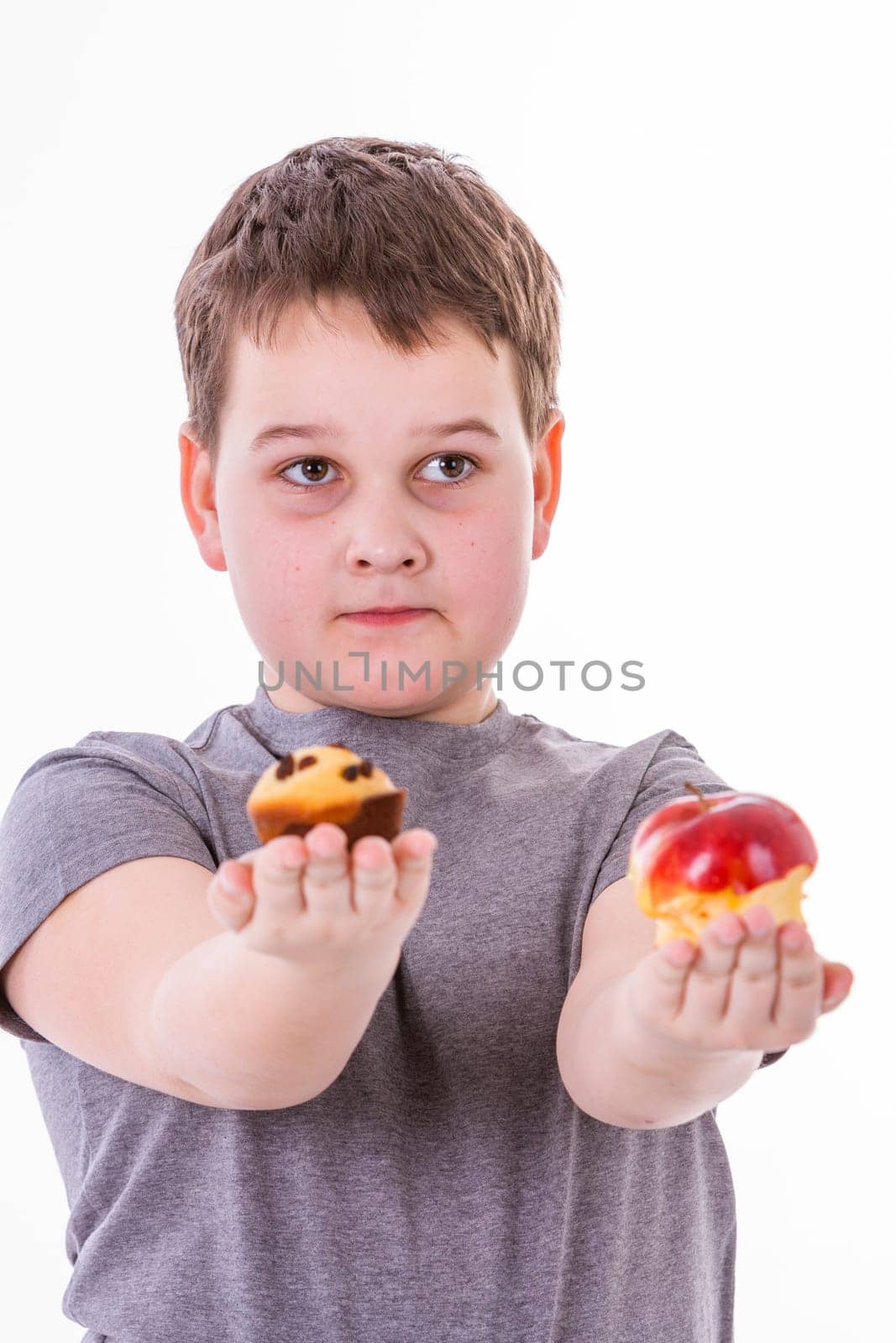 little boy with food isolated on white background - apple or a muffin