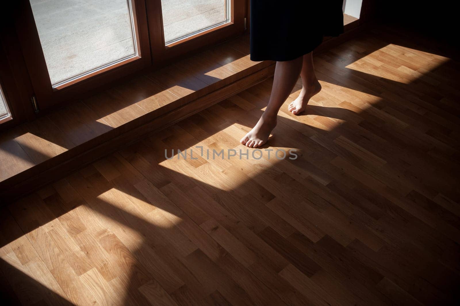 Closeup shot of female feet under bed at morning