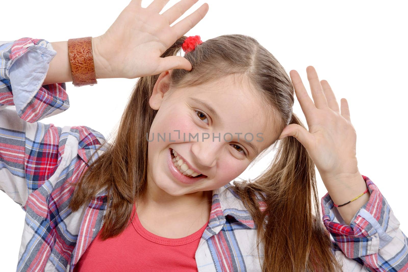 a funny little girl making faces, on white