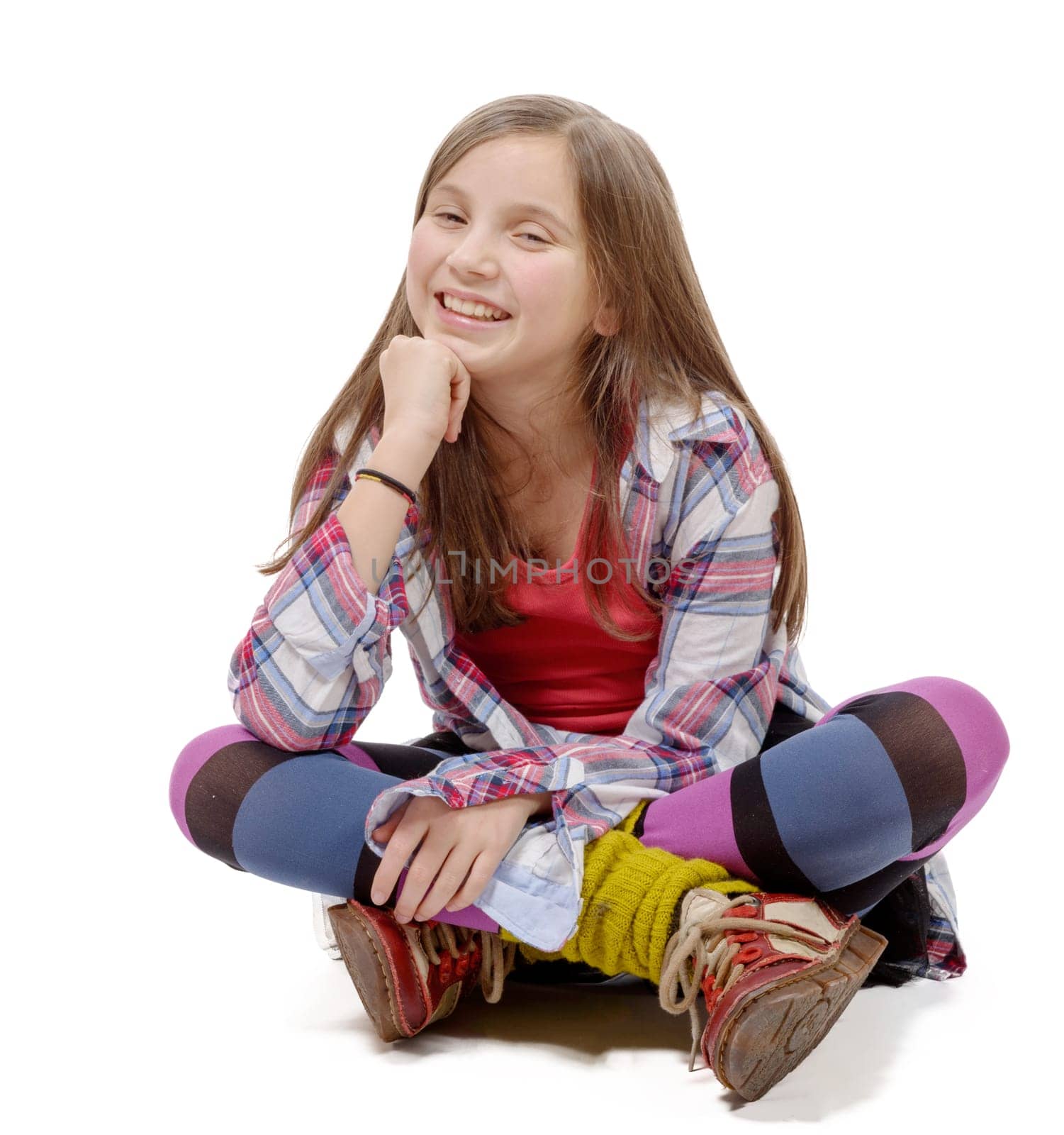 preteen girl in hipster style, sitting cross-legged on the floor