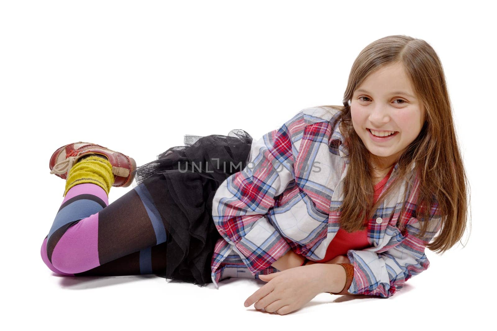 preteen girl in hipster style, lying on the floor, isolated on white background