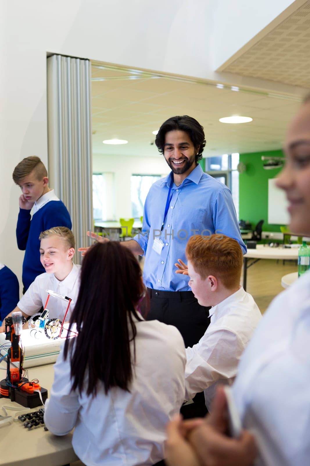 Technology teacher talking to his students during a lesson.