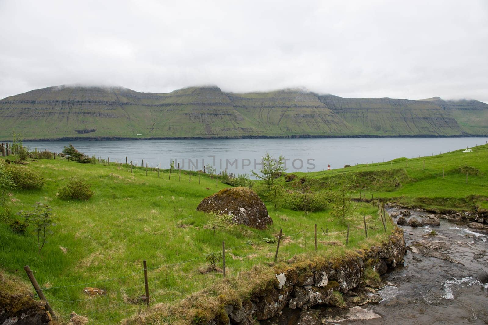 River on Kunoy and view towards Kalsoy on the Faroe Islands