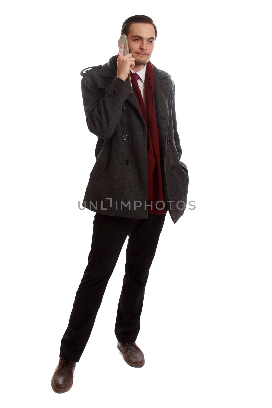 A formal businessman standing and talking on his phone