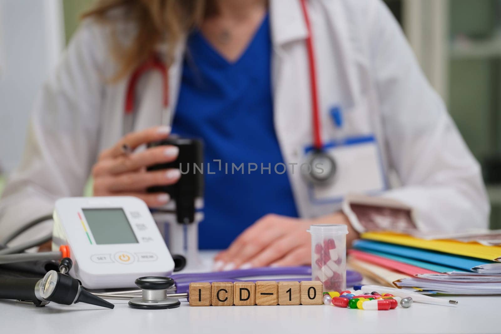 A qualified medical professional is analyzing crucial data with necessary tools and ICD10 code references