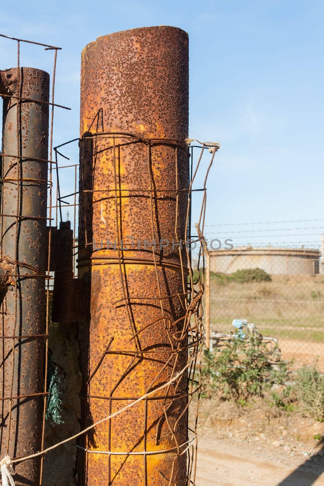 Rusted wire netting in industrial place. Particular of a pylon