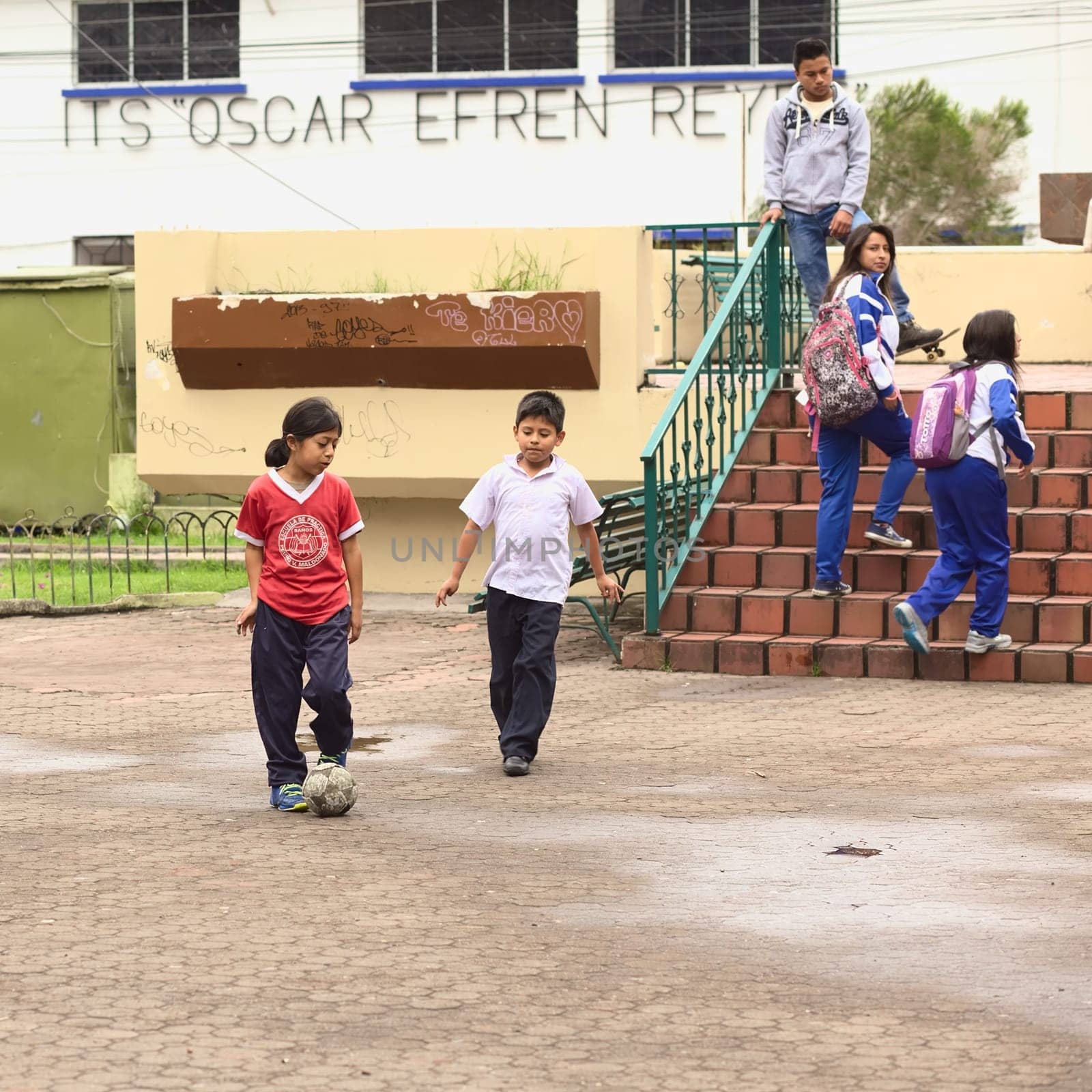 BANOS, ECUADOR - FEBRUARY 25, 2014: Unidentified children playing football in Sebastian Acosta Park on February 25, 2014 in Banos, Ecuador.