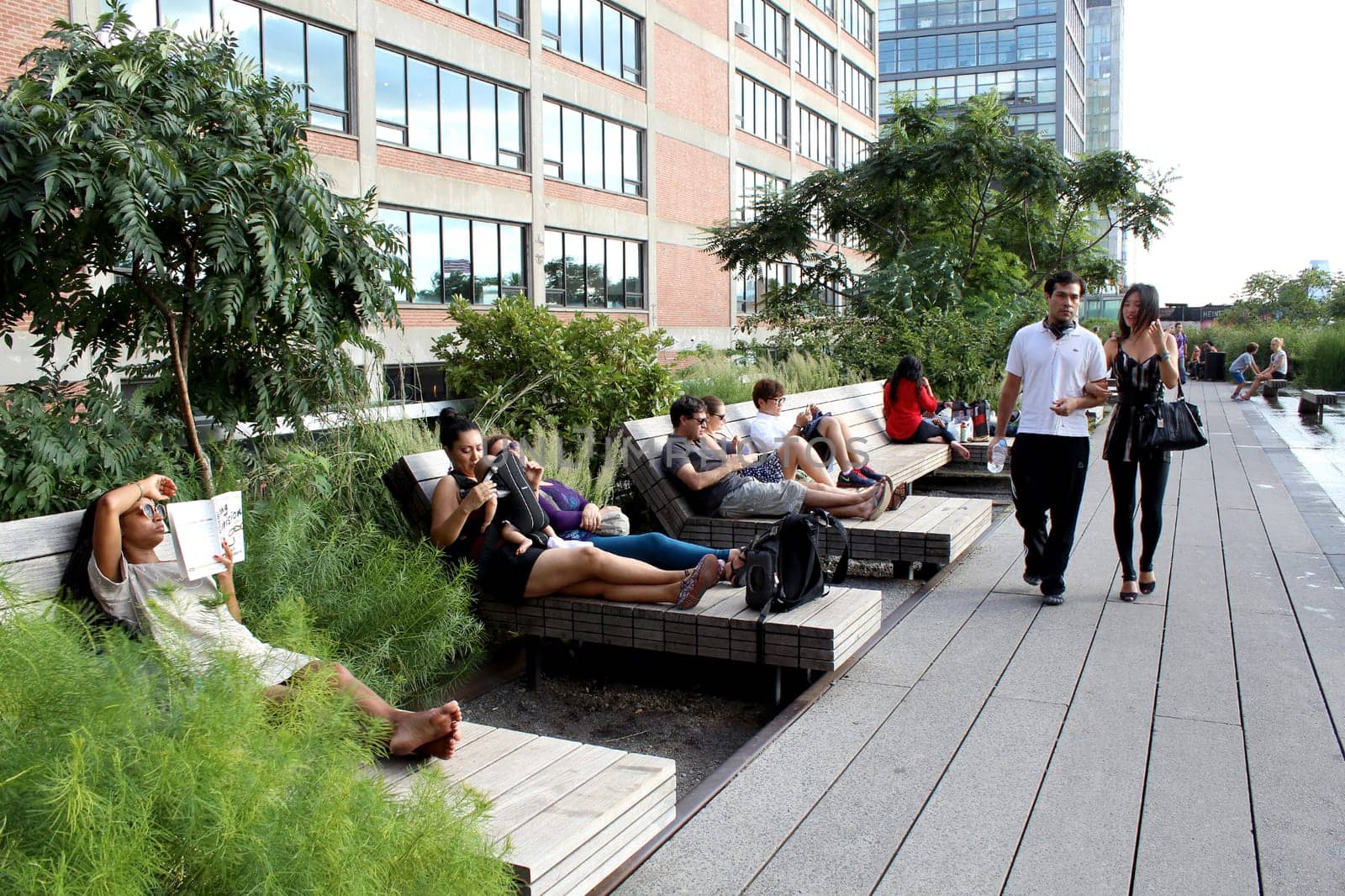 NEW YORK CITY - SEPTEMBER 03: People at High Line Park in NYC on September 03th, 2013. The High Line is a public park built on an historic freight rail line elevated above the streets on Manhattan West Side.