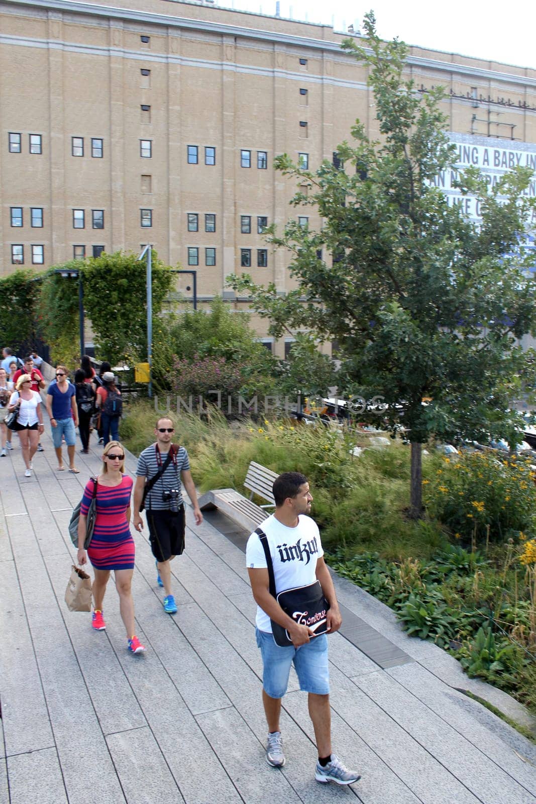 NEW YORK CITY - SEPTEMBER 03: People at High Line Park in NYC on September 03th, 2013. The High Line is a public park built on an historic freight rail line elevated above the streets on Manhattan West Side.