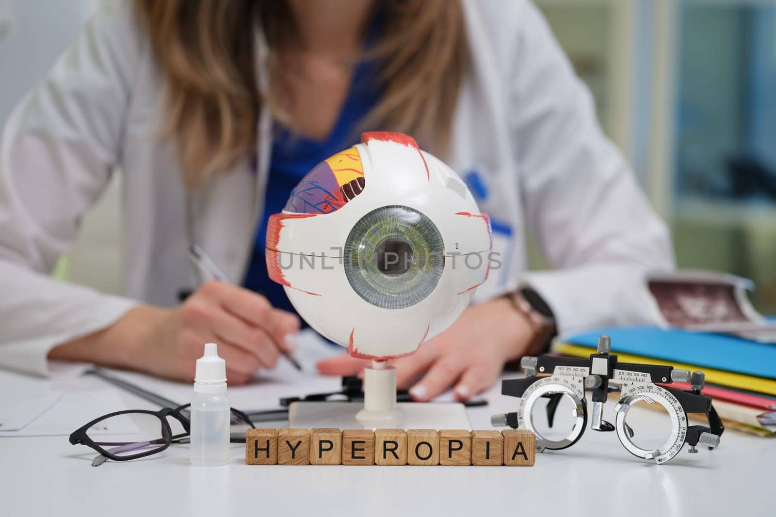 An optometrist thoroughly studies hyperopia by utilizing various models and tools in a clinical practice setting