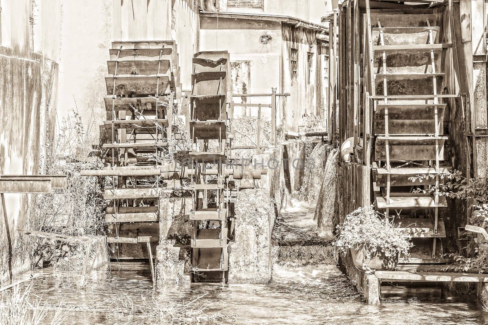 The carriages wheels of a water mill. Vintage style