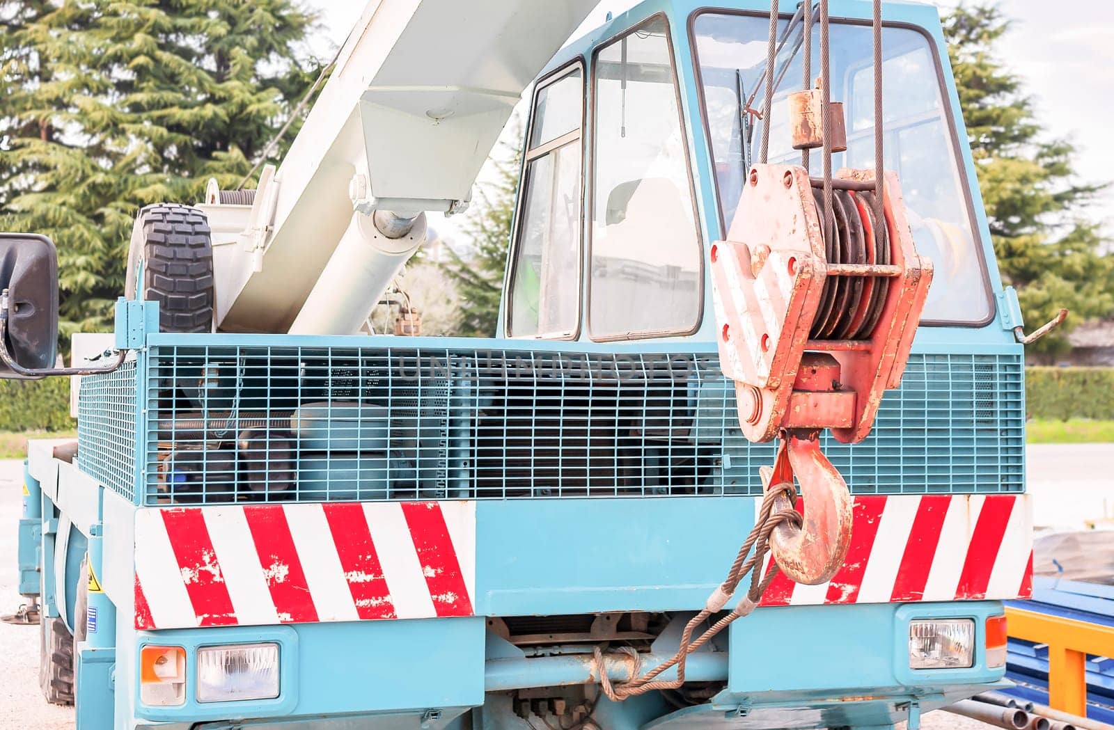 Truck crane, hook and pulley in the foreground