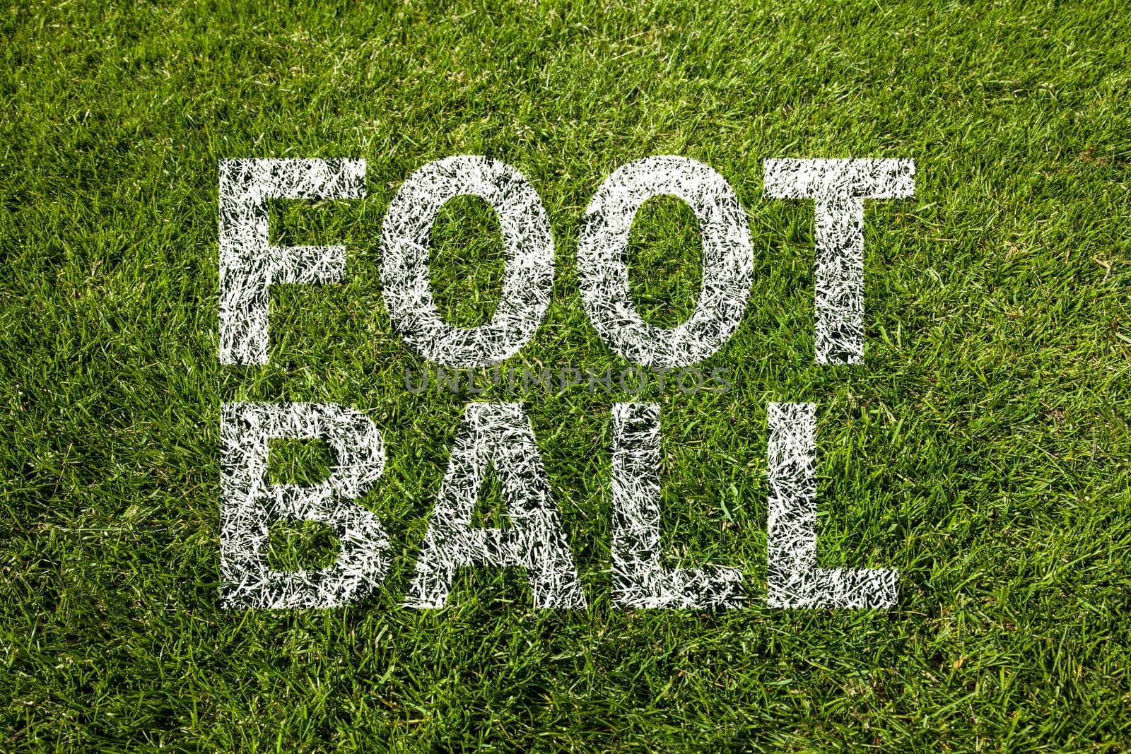 football text on a green meadow